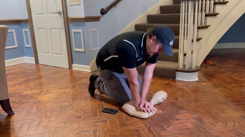Lewis demonstrates hands-only CPR to spread awareness on what to do if someone goes into...