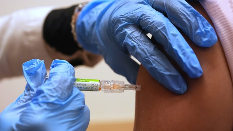 FILE - Pharmacy manager Aylen Amestoy administers a patient with a seasonal flu vaccine at a...