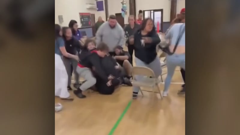 Stills from viewer video capture a brawl at a kindergarten graduation in Toledo, Ohio.