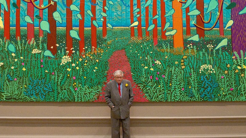 FILE - British artist David Hockney stands before one of his paintings of the East Yorkshire...